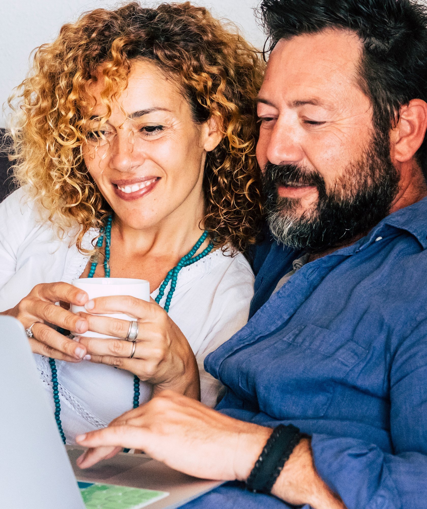 Couple reviewing their dental insurance benefits on a laptop at home Couple reviewing their dental insurance benefits on a laptop at home